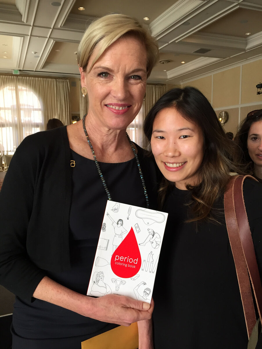 Andrea Yip holding the Period Coloring Book beside a supporter