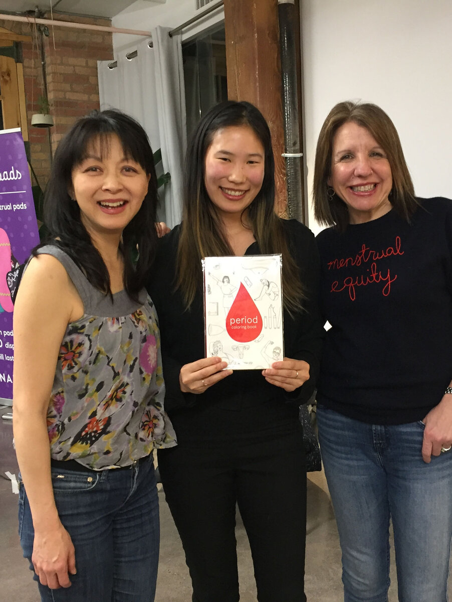 Andrea Yip with two supporters holding the Period Coloring Book